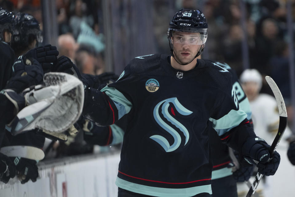 Seattle Kraken defenseman Vince Dunn celebrates with teammates on the bench after scoring a goal against the Boston Bruins during the third period of an NHL hockey game, Monday, Feb. 26, 2024, in Seattle. The Kraken won 4-3 in a shootout. (AP Photo/Stephen Brashear)