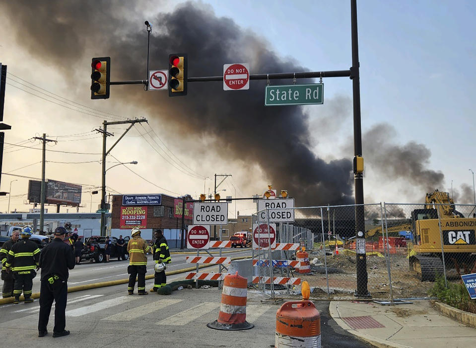 This image provided by the Philadelphia Fire Department shows officials working on the scene following a collapse on I-95 after a truck fire, Sunday, June 11, 2023, in Philadelphia. The elevated section of Interstate 95 has collapsed early Sunday after a vehicle caught fire, closing the main north-south highway on the East Coast and threatening to upend travel in parts of the densely populated Northeast. (Philadelphia Fire Department via AP)