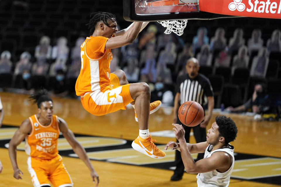 Tennessee's Keon Johnson dunks the ball over Vanderbilt's Braelee Albert, right, in the second half of an NCAA college basketball game Wednesday, Feb. 24, 2021, in Nashville, Tenn. (AP Photo/Mark Humphrey)