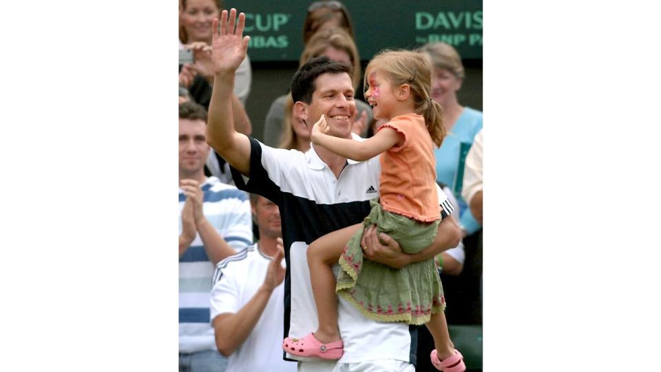 tim henman holding daughter on the pitch