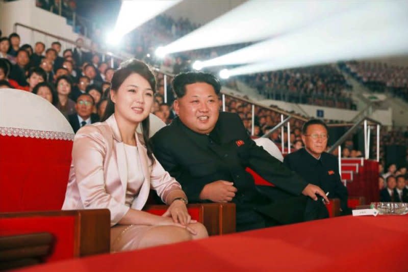 North Korean leader Kim Jong-un (R) and his wife Ri Sol-ju (L) watch a joint performance given by the State Merited Chorus and the Moranbong Band, a popular all-female music band, to mark the 70th anniversary of the founding of the ruling Workers' Party of Korea on October 19, 2015. On July 25, 2012, North Korea announced Kim married Ri. File Photo courtesy of Rodong Sinmun