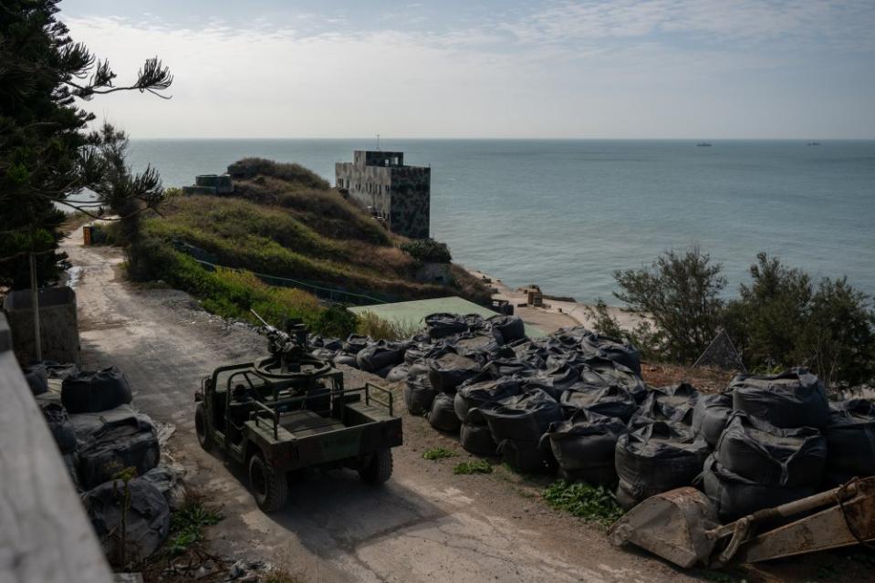 A military patrol drives around Greater Qiu Island on Jan. 14. Chinese boats are seen in the distance.<span class="copyright">Mike Kai Chen for TIME</span>