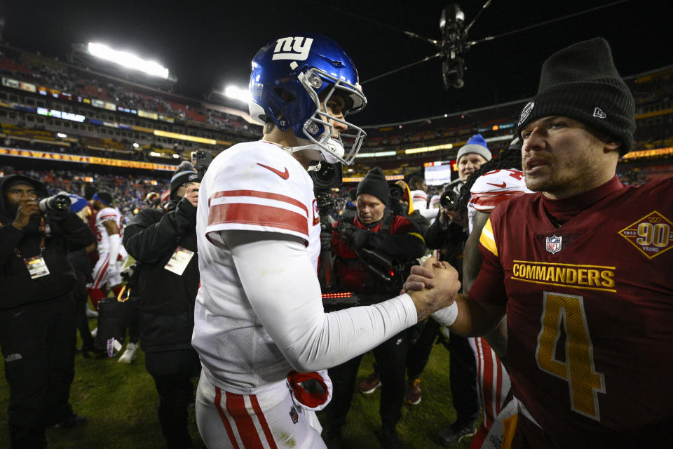 New York Giants quarterback Daniel Jones, left, shakes hands with Washington Commanders quarterback Taylor Heinicke after a 20-12 victory, Sunday, Dec. 18, 2022, in Landover, Md. (AP Photo/Nick Wass)