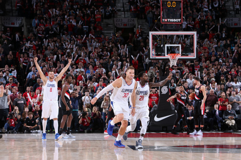 Blake Griffin and Patrick Beverley celebrate Griffin’s game-winning shot to beat the Trail Blazers in Portland. (Getty)