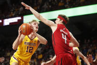 Minnesota guard Luke Loewe (12) works to the basket around Rutgers guard Paul Mulcahy (4) in the first half of an NCAA college basketball game Saturday, Jan. 22, 2022, in Minneapolis. (AP Photo/Bruce Kluckhohn)