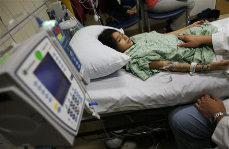 Patient Analy Navarro receives treatment from Doctor Leon Yeh in the Emergency Room at OSF Saint Francis Medical Center in Peoria, Illinois, November 26, 2013. REUTERS/Jim Young