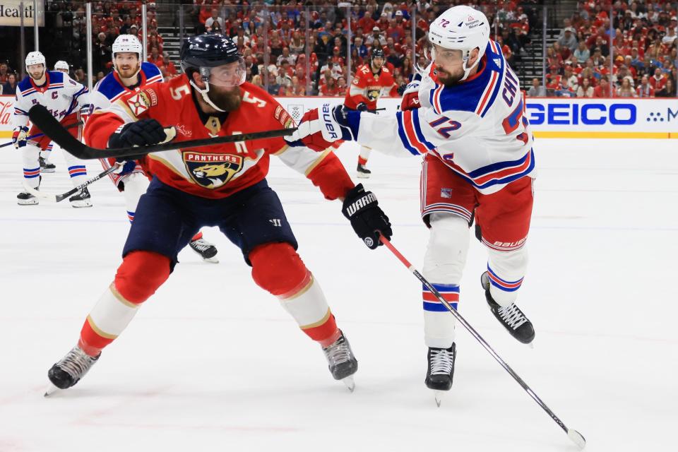 SUNRISE, FLORIDA - JUNE 01: Filip Chytil #72 of the New York Rangers plays the puck past Aaron Ekblad #5 of the Florida Panthers during the first period in Game Six of the Eastern Conference Final of the 2024 Stanley Cup Playoffs at Amerant Bank Arena on June 01, 2024 in Sunrise, Florida.