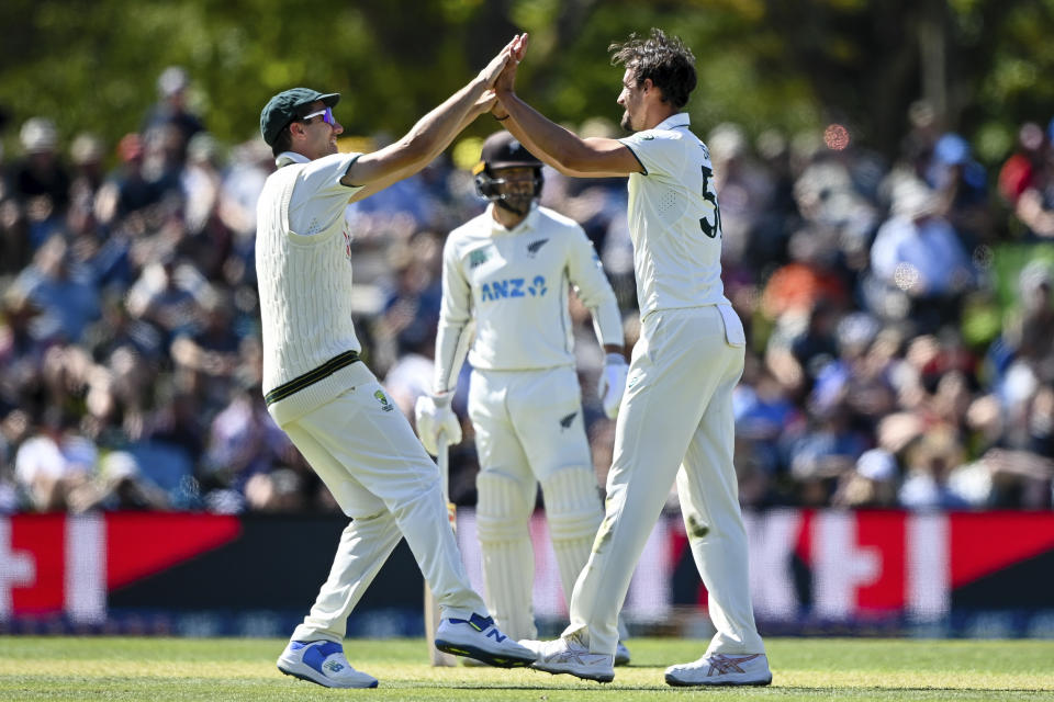 Mitchell Starc, right, of Australia is congratulated by teammate Pat Cummins after taking the wicket of New Zealand's Glenn Phillips on day one for the second cricket test between New Zealand and Australia in Christchurch, New Zealand, Friday March 8, 2024. (John Davidson/Photosport via AP)