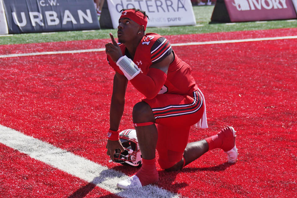 Utah quarterback Nate Johnson (13) takes a knee before the start of an NCAA college football game against Weber State, Saturday, Sept. 16, 2023, in Salt Lake City. (AP Photo/Rick Bowmer)