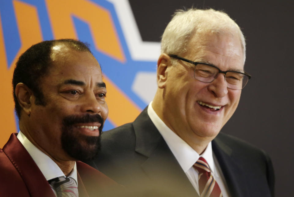 Former New York Knicks player Walt Frazier, left, joins Phil Jackson, the newly named president of the Knicks, at a news conference Tuesday, March 18, 2014 in New York. Frazier and Jackson are former teammates with the Knicks. (AP Photo/Mark Lennihan)