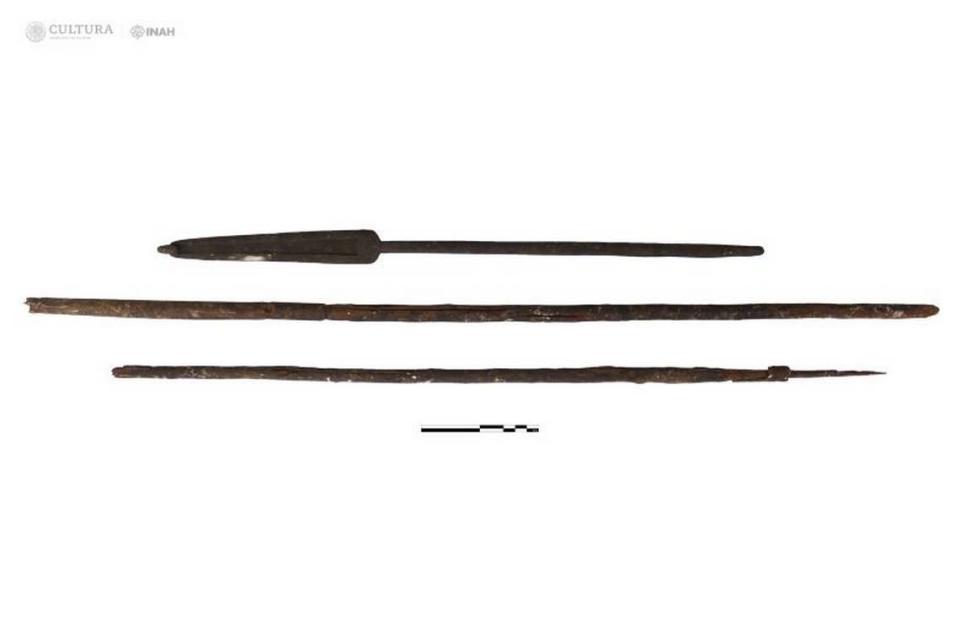 The dart thrower with the two wooden darts recovered from the cave.