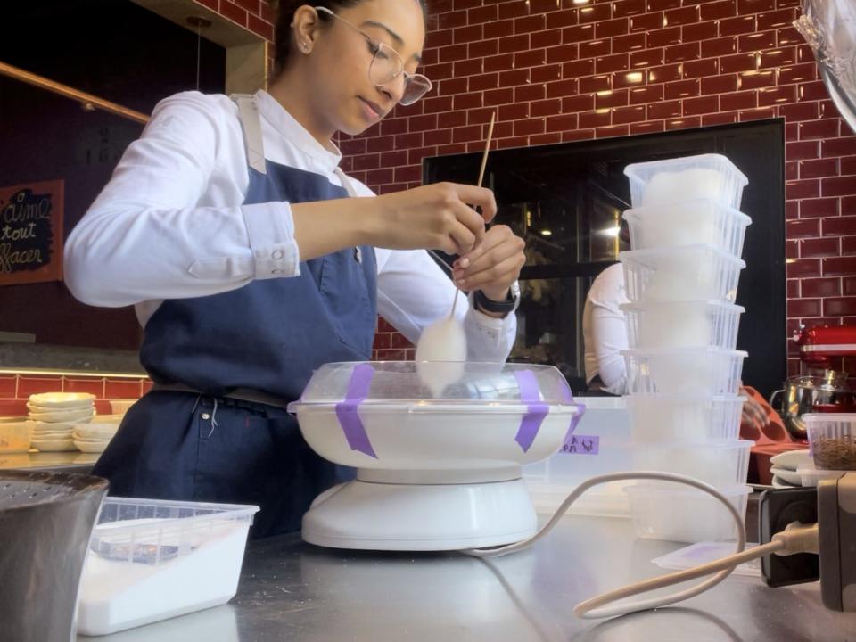 The writer spins sugar in a piece of kitchen equipment