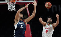 France's Rudy Gobert (27), left, and Iran's Arsalan Kazemi (41) fight for a rebound during men's basketball preliminary round game at the 2020 Summer Olympics, Saturday, July 31, 2021, in Saitama, Japan. (AP Photo/Charlie Neibergall)