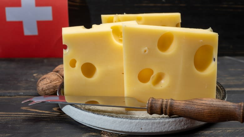 Emmentaler cheese on cutting board with knife