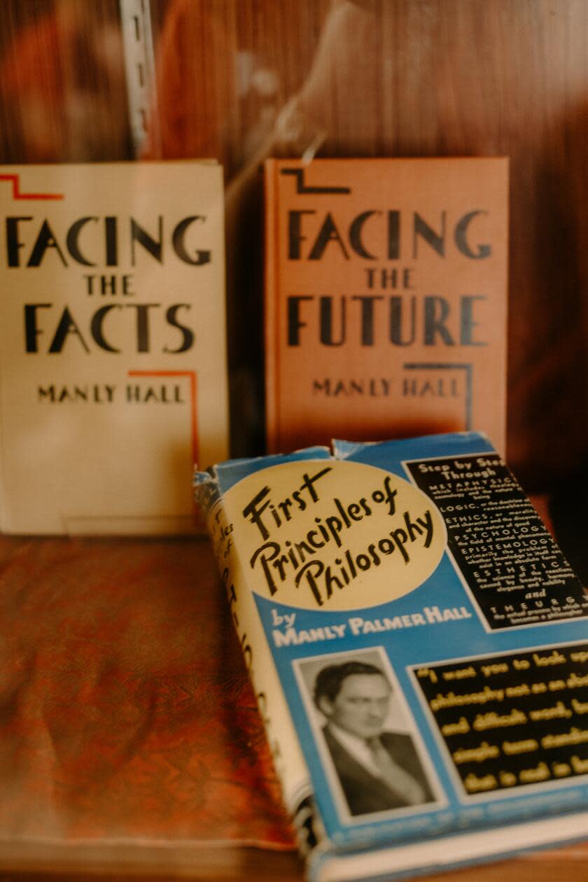 Books by Manly Hall sitting in a glass case.