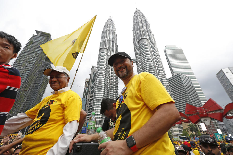 FILE- In this Nov. 19, 2016, file photo, Malaysia's former Prime Minister Mahathir Mohamad, left, arrives at a rally by the Coalition for Clean and Fair Elections (Bersih), in Kuala Lumpur, Malaysia. Malaysia's king accepted Mahathir's shocking resignation Monday, Feb. 24, 2020, that came in tandem with plans by his supporters to team up with opposition parties to form a new government and foil the transition of power to his named successor, Anwar Ibrahim.(AP Photo/Vincent Thian, File)