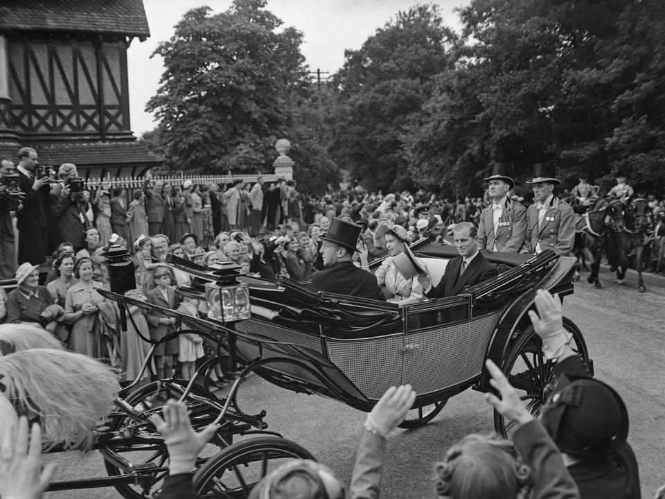 Queen Elizabeth and Prince Philip, with Master of the Horse the Duke of Beaufort, arriving at the Golden Gate in an open landau to attend the Ascot races on June 17, 1952.