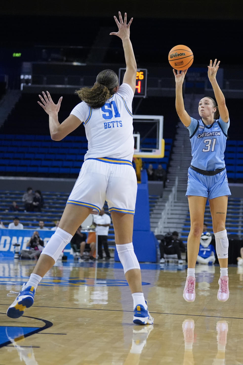 Creighton forward Emma Ronsiek makes a 3-point basket over UCLA center Lauren Betts (51) during the first half of a second-round college basketball game in the women's NCAA Tournament Monday, March 25, 2024, in Los Angeles. (AP Photo/Marcio Jose Sanchez)