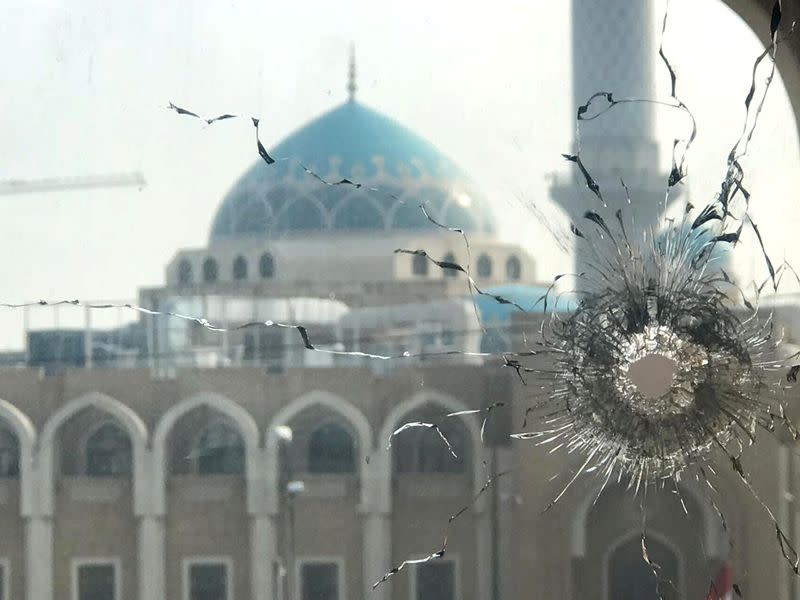 A broken window is seen in front al Hakim shrine during ongoing anti-government protests in Najaf