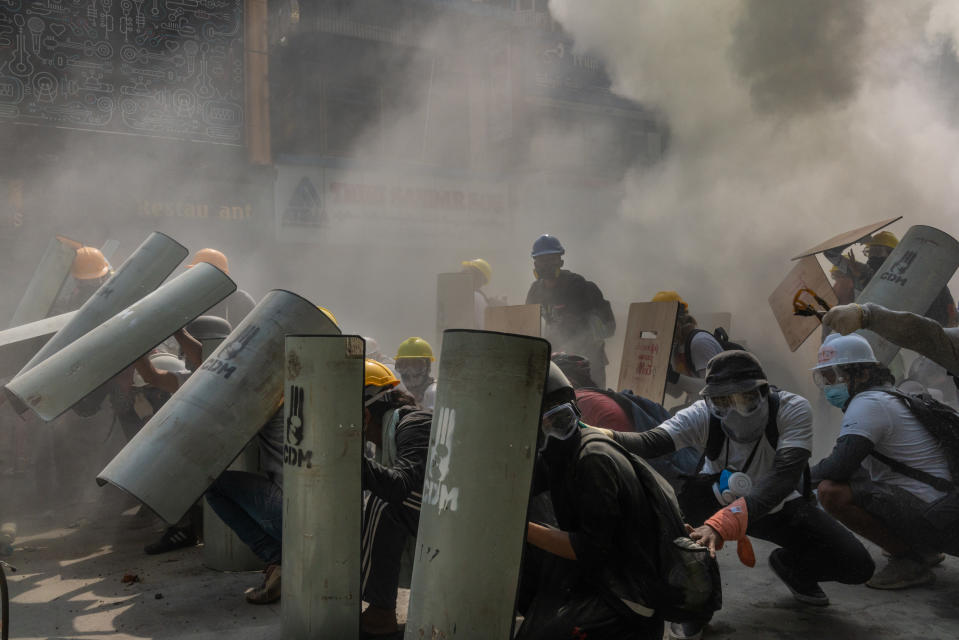 Protesters defend themselves with makeshift shields during clashes with riot police on February 28, 2021 in Yangon, Myanmar.<span class="copyright">Hkun Lat/Getty Images</span>