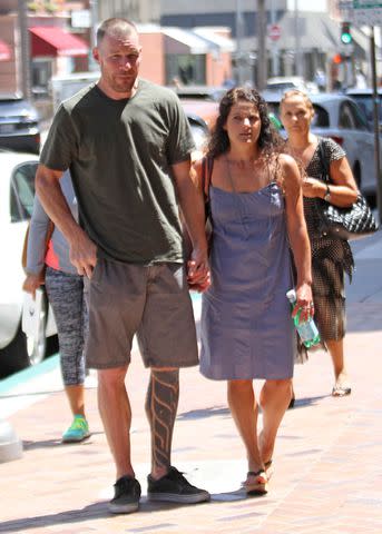 <p>WENN Rights Ltd/Alamy</p> Tim Commerford of Rage Against the Machine and Aleece Dimas in Los Angeles in August 2015