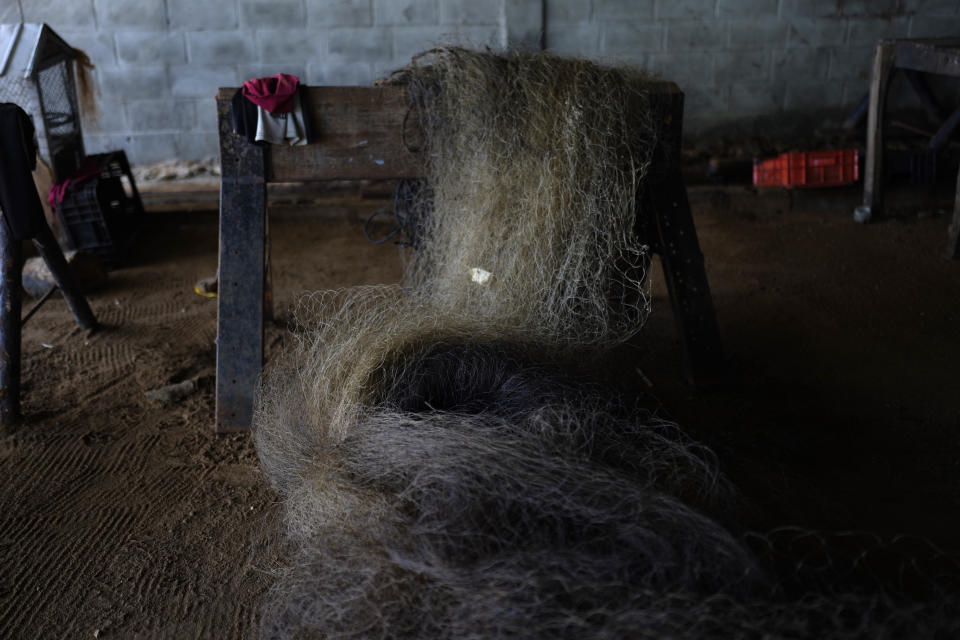 An oil-stained fishing net is stored in a home in San Francisco, Venezuela, Wednesday, Aug. 9, 2023. The pollution around the Lake Maracaibo, one of Latin America's largest, is the result of decades of excessive oil exploitation on its bed, inadequate maintenance, and a lack of investment to improve an already obsolete infrastructure, according to environmentalists. (AP Photo/Ariana Cubillos)