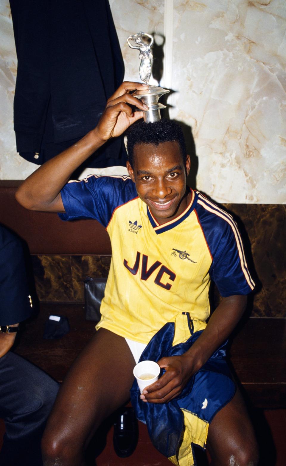 Michael Thomas celebrates with the championship trophy in the locker room in 1989 (Getty Images)