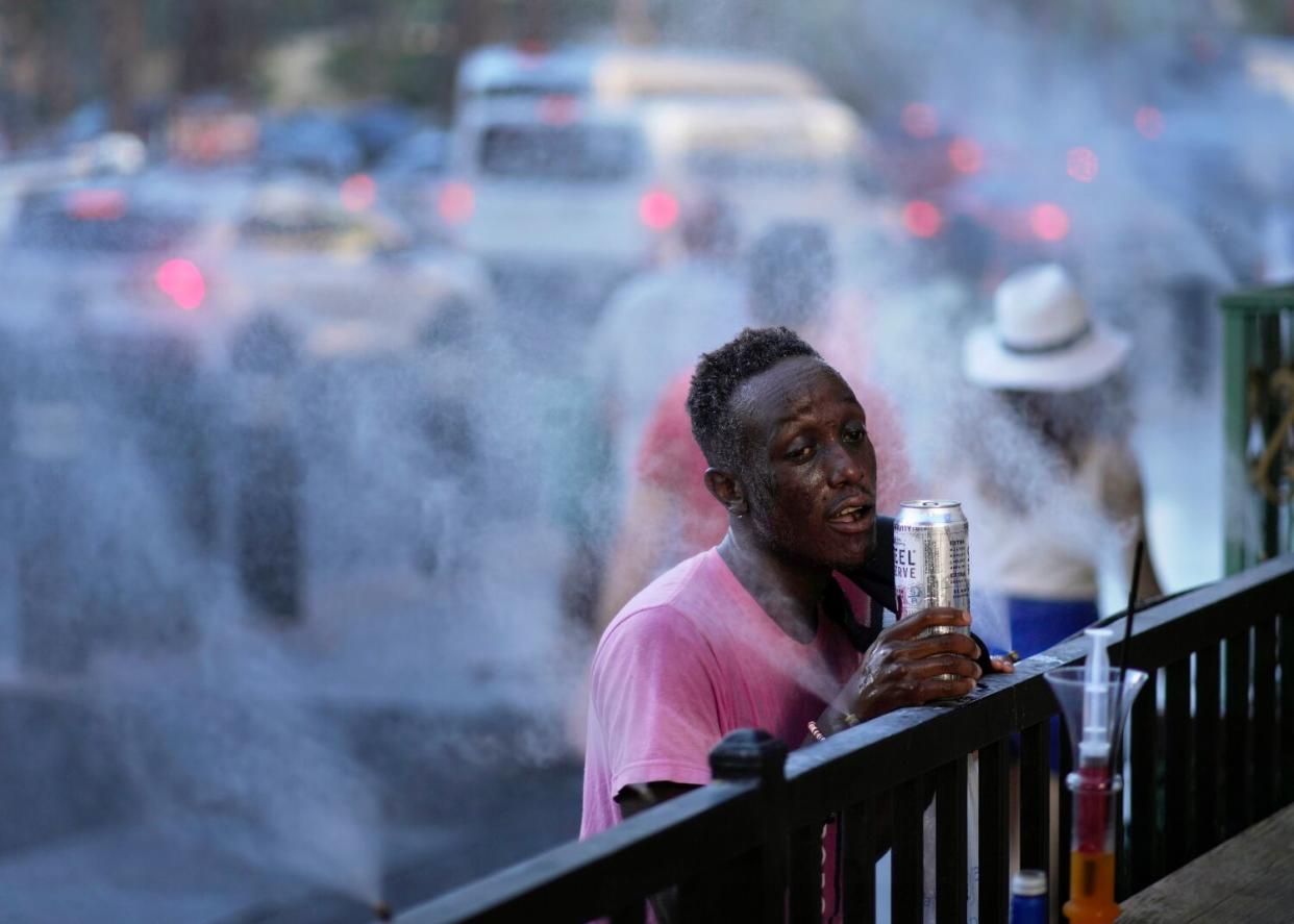 A man cools off in misters along the Las Vegas Strip