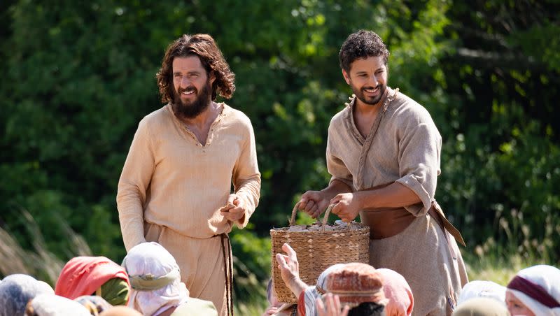 Actors Jonathan Roumie, who plays Jesus, and Alaa Safi, who plays Simon the Zealot, film the feeding of the 5,000 scene for “The Chosen.”