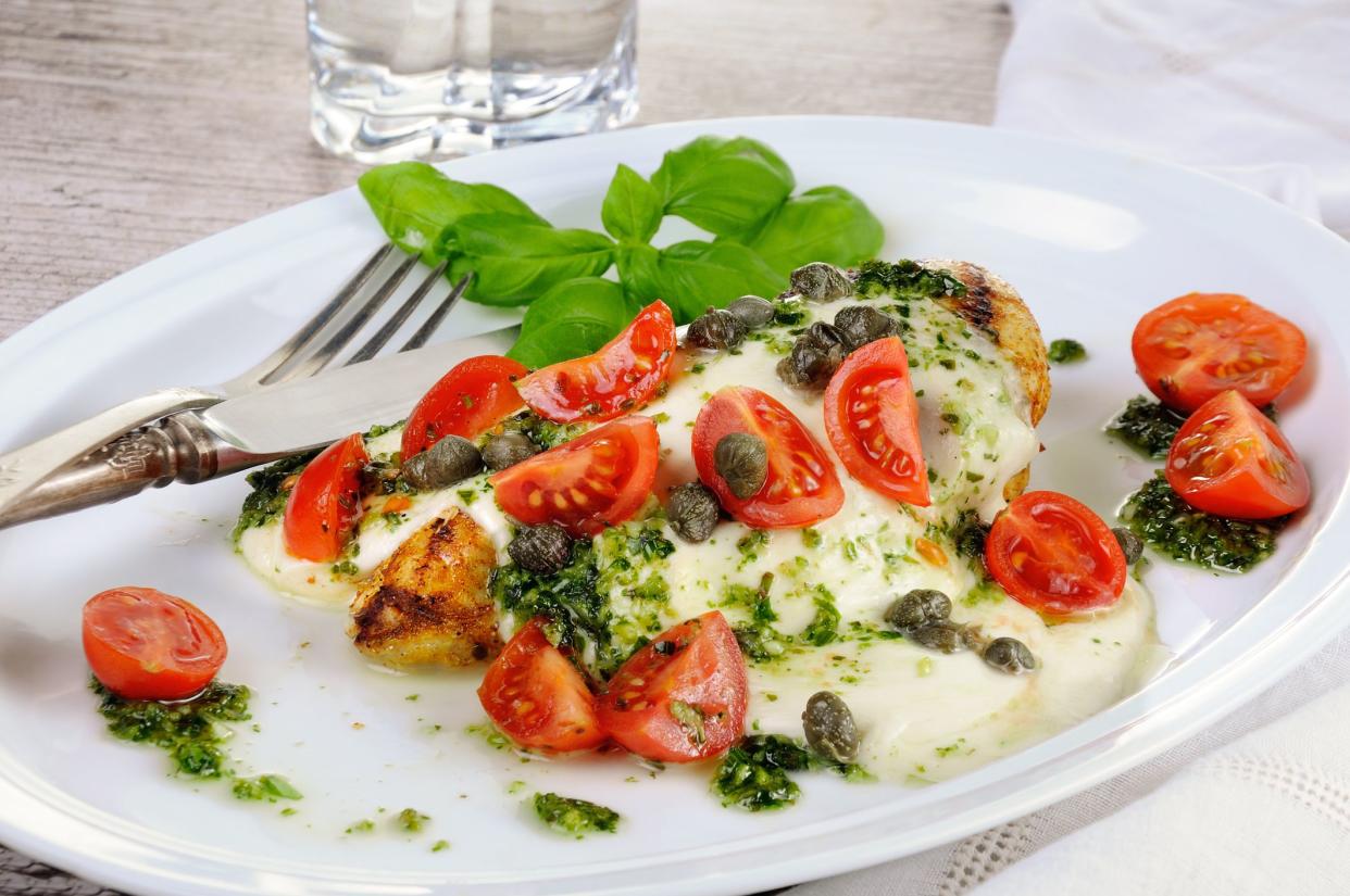 grilled chicken breast  topped with melted mozzarella cheese, basil  pesto, tomato  and caper