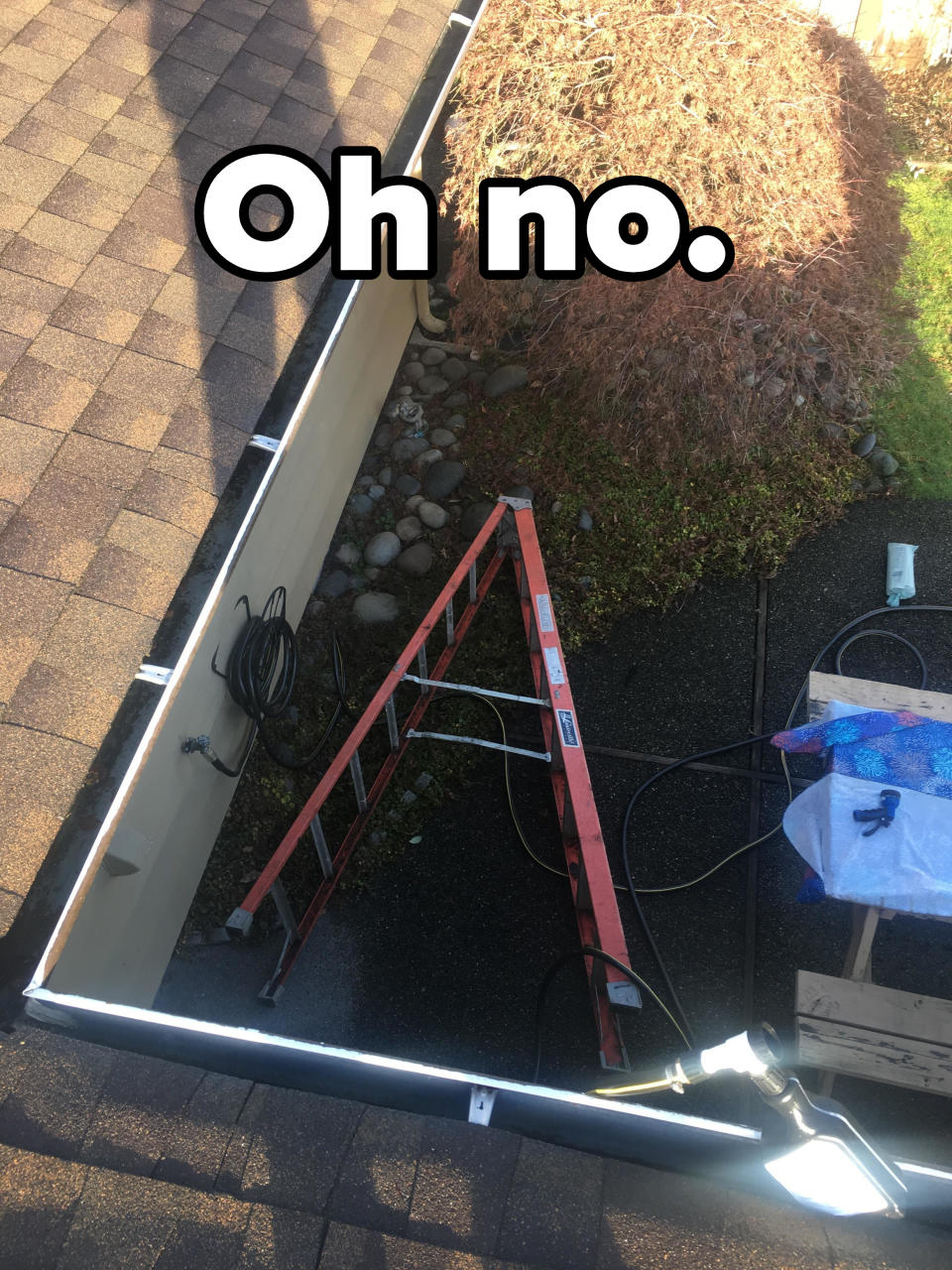 A tipped-over ladder seen from a roof, with text saying, "Oh no"
