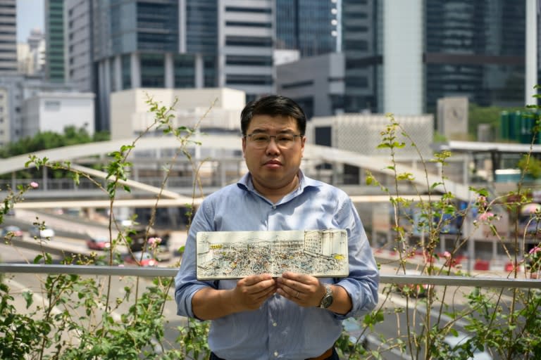 Artist Alvin Wong, founder of Hong Kong's Urban Sketchers group, poses with a drawing that he produced during the 2014 Umbrella Movement pro-democracy protests in the Admiralty district of Hong Kong