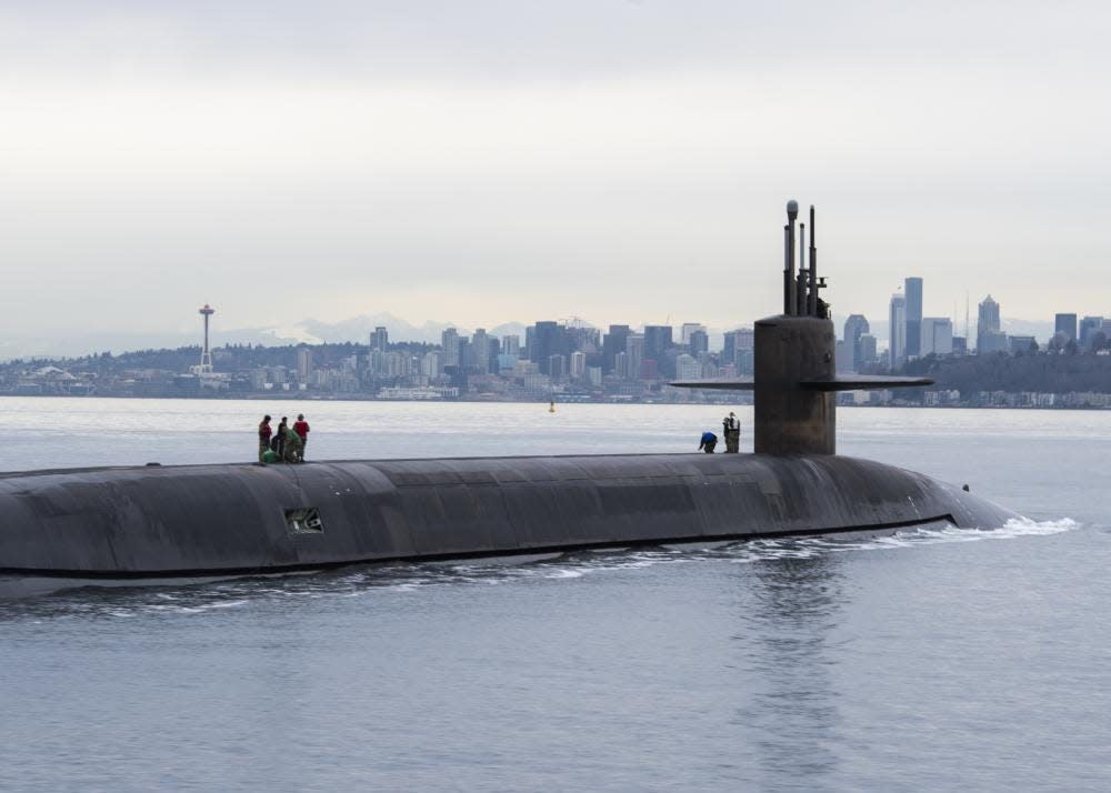The Ohio-class ballistic missile submarine USS Louisiana (SSBN 743) transits Puget Sound past the Seattle skyline following a 41-month engineered refueling overhaul at the Puget Sound Naval Shipyard on Feb. 9. The Louisiana returns to Bangor on Feb. 17.