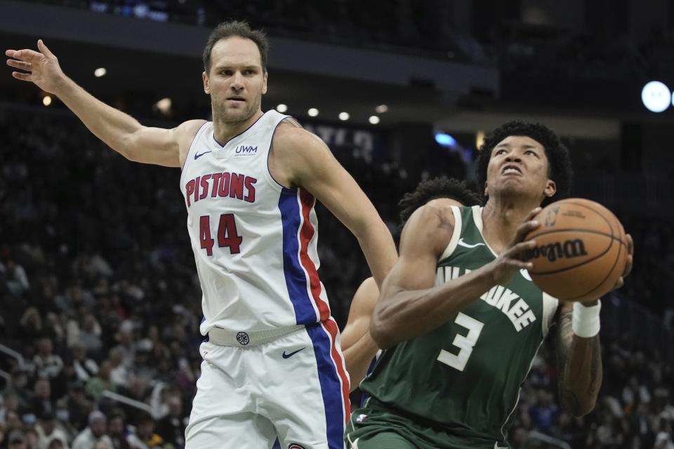 Milwaukee Bucks' MarJon Beauchamp shoots past Detroit Pistons' Bojan Bogdanovic during the first half of an NBA basketball game Saturday, Dec. 16, 2023, in Milwaukee. (AP Photo/Morry Gash)