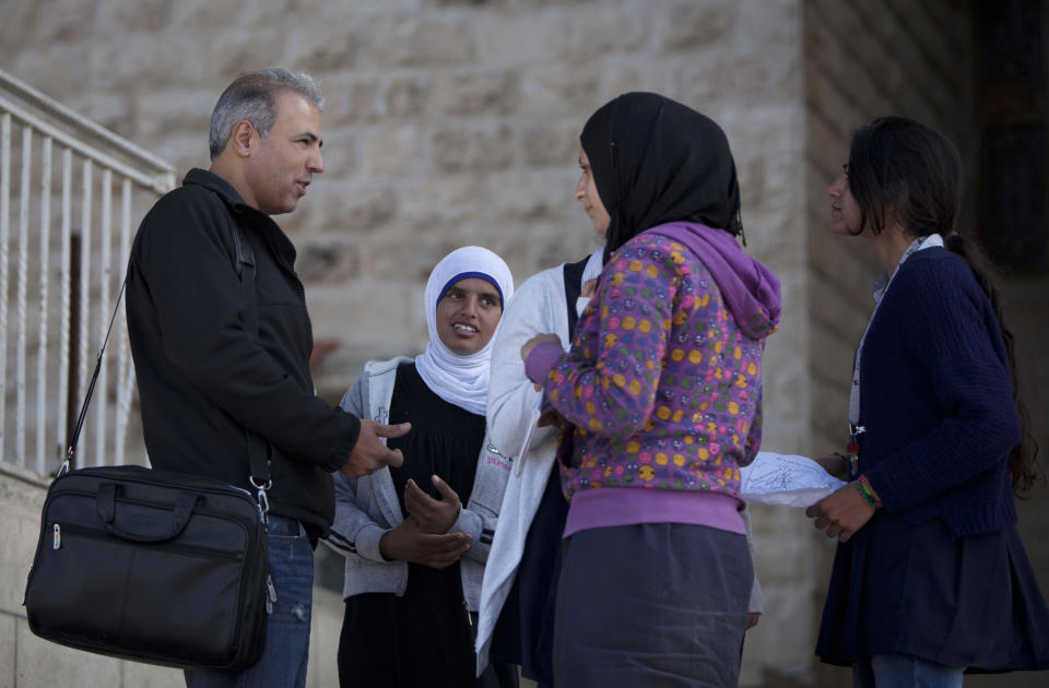 In this Thursday, April 3, 2014 photo, Palestinian Esmat Mansour, a former prisoner who was released after 20 years in Israeli jail, talks to his Hebrew students at a school in the village of Taybeh, near the West Bank city of Ramallah. Mansour was 16 when, in October 1993, he helped three older teens stab to death an Israeli man. Mansour said the time in Israeli prison changed him. (AP Photo/Majdi Mohammed)