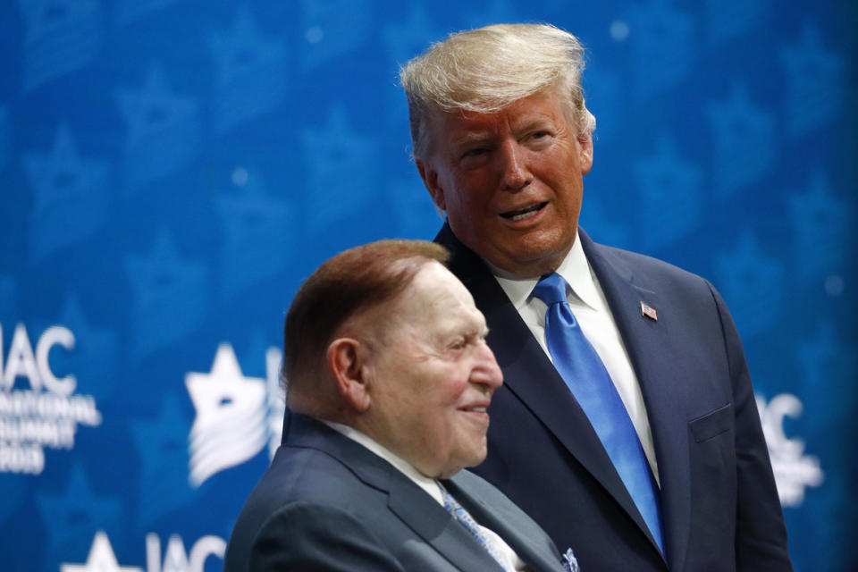 President Donald Trump speaks with Sheldon Adelson  at the Israeli American Council National Summit in Hollywood, Fla., on Dec. 7, 2019.  