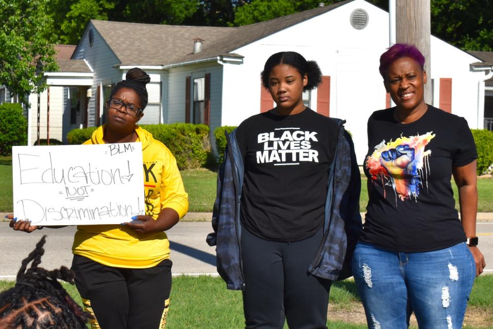 Black Lives Matter supporters stand in front of an Ardmore elementary school Wednesday, May 5, 2021, to protest recent school actions against students wearing Black Lives Matter shirts,