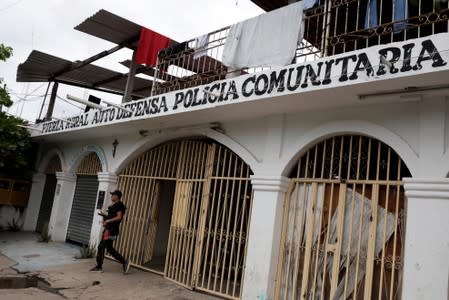 A vigilante is pictured leaving the command headquarters in the municipality of Coahuayana