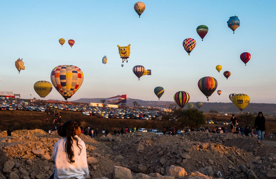 Girl watching hot-air balloons