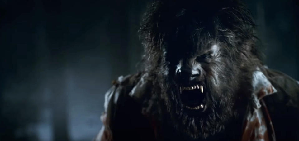 A snarling werewolf, with fangs bared and eyes glowing, wearing a torn shirt, in a dark and foggy setting