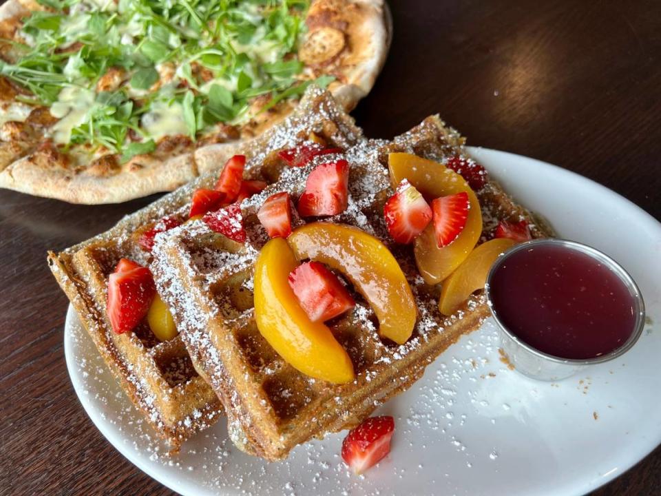 Blue-corn waffles with fruit and a breakfast pizza at Olivella’s in Fort Worth July 16, 2023.