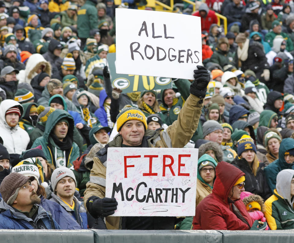 A fan holds up a sign directed towards Green Bay Packers head coach Mike McCarthy during the second half of an NFL football game against the Arizona Cardinals Sunday, Dec. 2, 2018, in Green Bay, Wis. (AP Photo/Jeffrey Phelps)