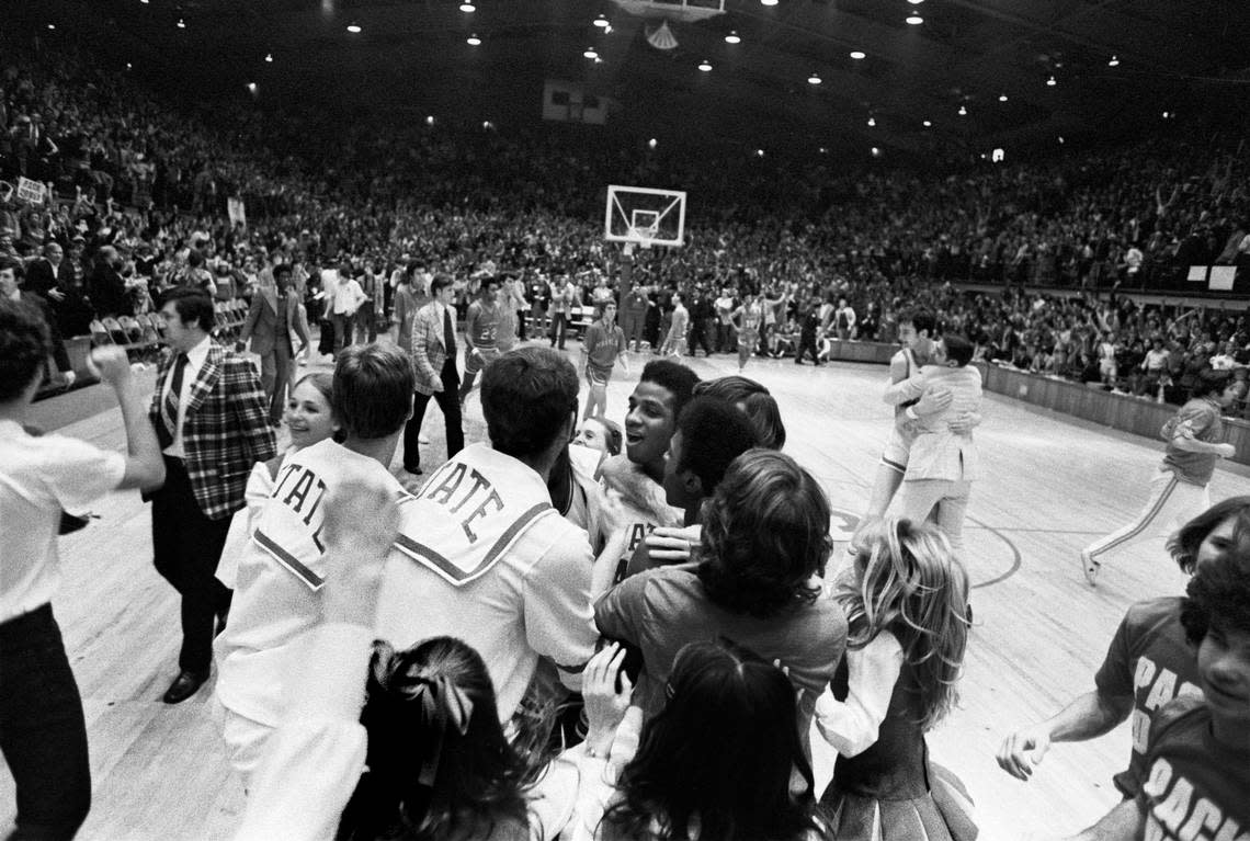 NC State’s David Thompson is mobbed by players, fans and cheerleaders following the Wolfpack’s win over Maryland Reynolds Coliseum in 1974.