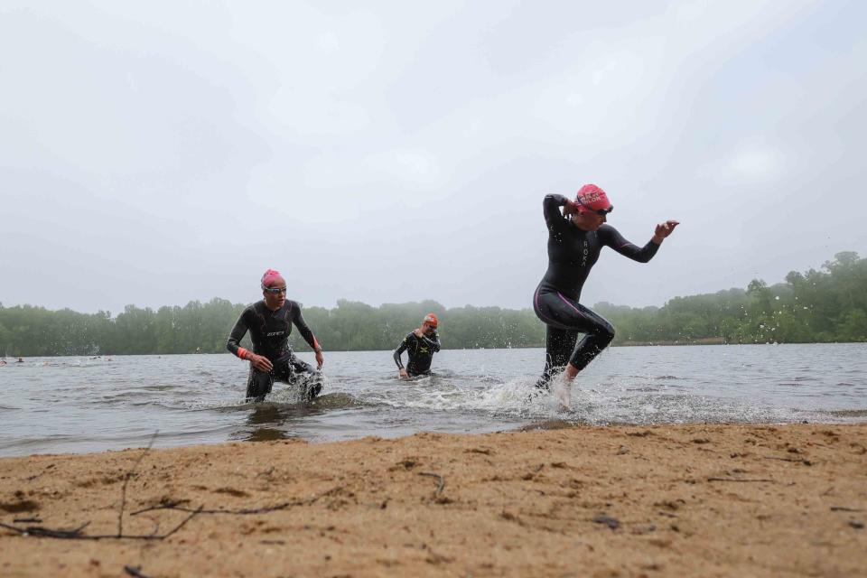 Competitors emerge from the swimming leg of the Bear Triathlon on May 15 at Lums Pond State Park.