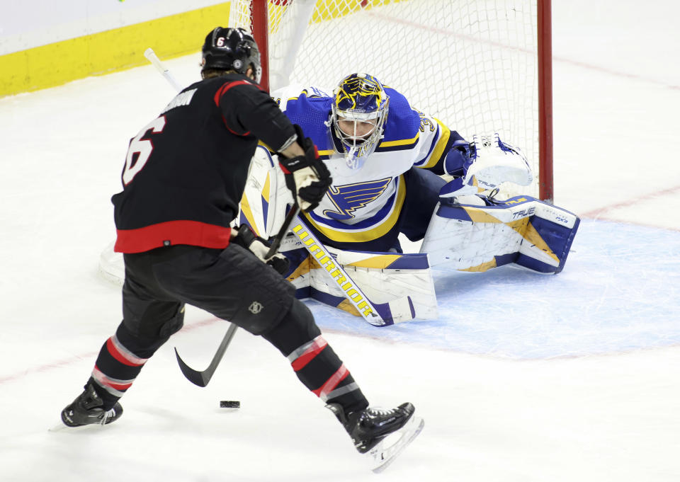 Ottawa Senators' Jakob Chychrun (6) is stopped by St. Louis Blues goaltender Joel Hofer (30) during the first period of an NHL hockey game in Ottawa, Ontario, on Thursday, March 21, 2024. (Patrick Doyle/The Canadian Press via AP)