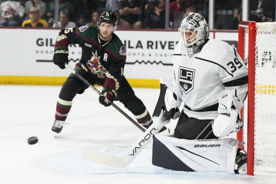 Los Angeles Kings goaltender Cam Talbot (39) makes a save in front of Arizona Coyotes center Alexander Kerfoot, left, in the second period during an NHL hockey game, Friday, Oct. 27, 2023, in Tempe, Ariz. (AP Photo/Rick Scuteri)