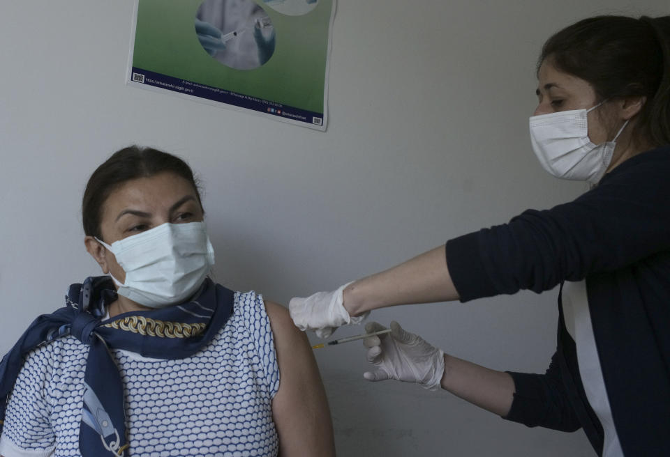 A nurse administers the second dose of Pfizer COVID-19 vaccine to a person at a hospital, in Ankara, Turkey, Saturday, May 1, 2021. Turkish President Recep Tayyip Erdogan imposed the new lockdown restrictions that will last until May 17, spanning the holy Muslim month of Ramadan and the Eid holiday, after COVID-19 infections and fatalities hit record high levels. (AP Photo/Burhan Ozbilici)