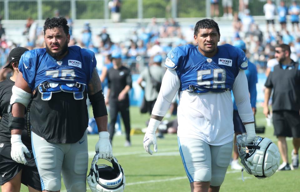 Lions offensive guard Jonah Jackson, left, and offensive tackle Penei Sewell walk off the field during training camp on Thursday, Aug. 3, 2023, in Allen Park.