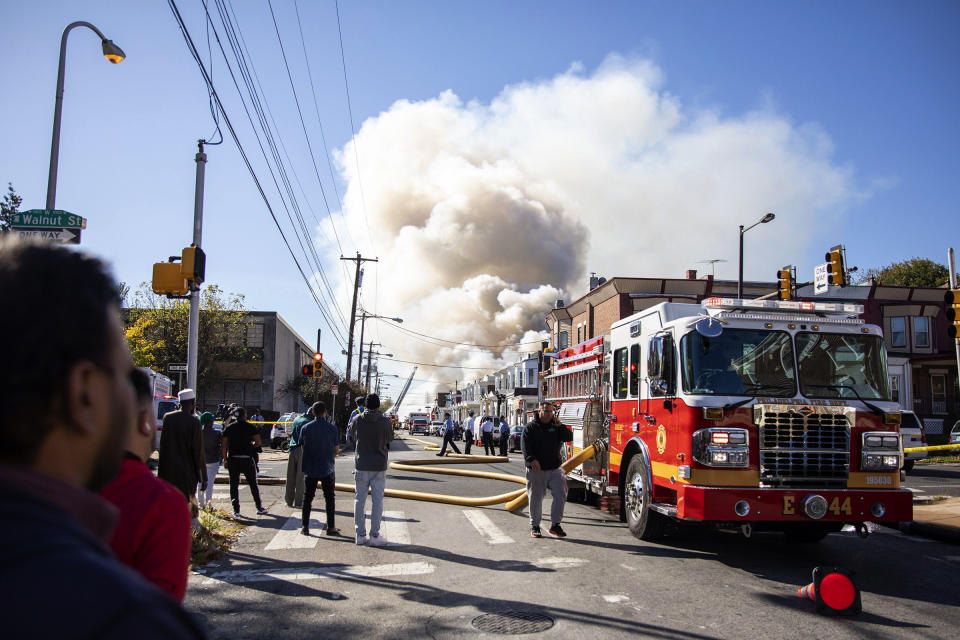 West Philadelphia Fire Department firefighters put out a fire that broke out Monday, Oct. 21, 2019, in Philadelphia. (Tyger Williams/The Philadelphia Inquirer via AP)