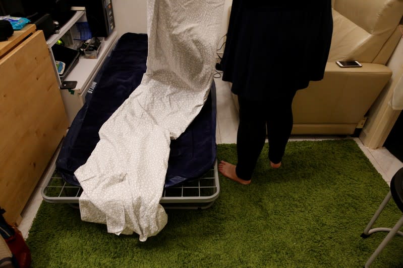 Katrina prepares a bed for anti-government protesters at her apartment in Hong Kong